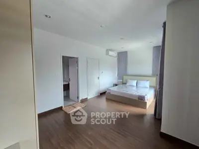 Spacious bedroom with modern design and wooden flooring