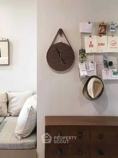 Cozy living room corner with stylish wall clock and organized bulletin board.