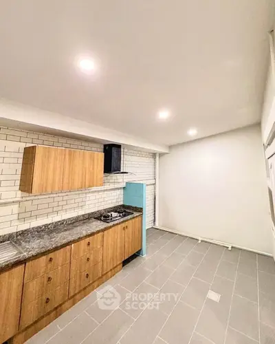 Modern kitchen with sleek cabinetry and gas stove in a spacious layout.