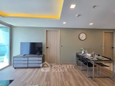 Modern living room with dining area, sleek furniture, and ambient lighting