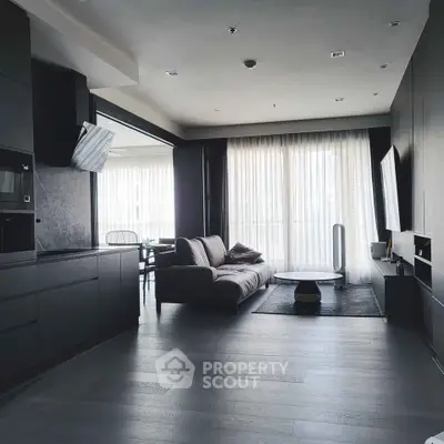 Modern living room with sleek design, large windows, and stylish furniture in a contemporary apartment.