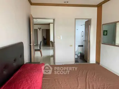Spacious bedroom with ensuite bathroom in modern apartment