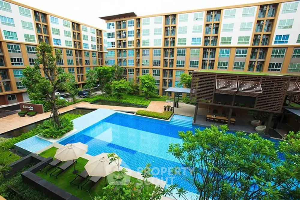 Luxurious apartment complex with stunning pool and lush garden view.