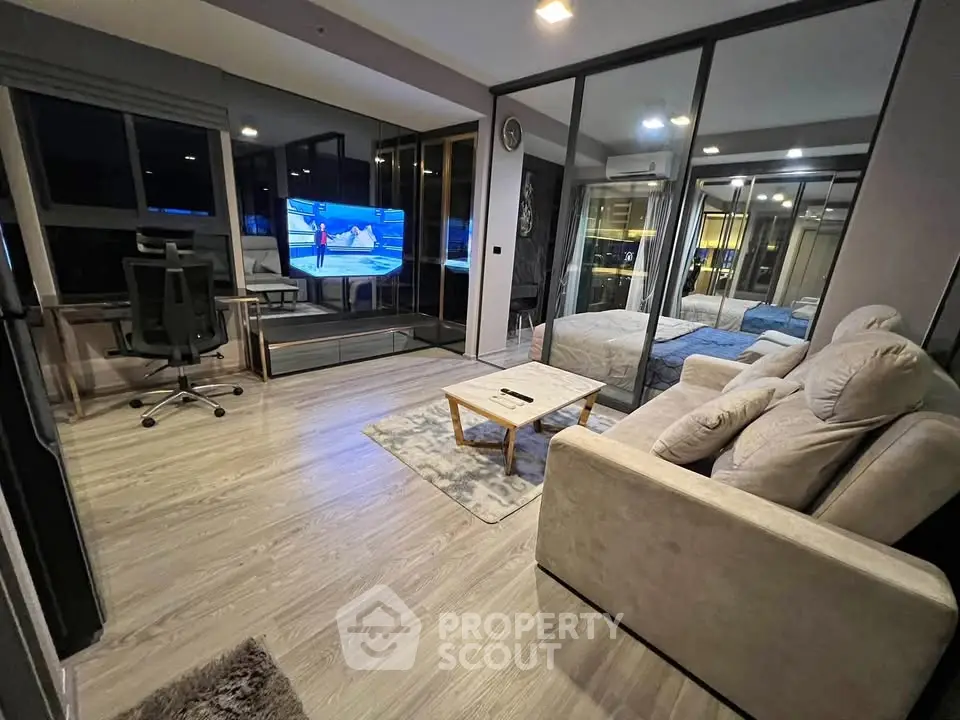 Modern living room with sleek design and large windows, featuring a cozy sofa and stylish decor.