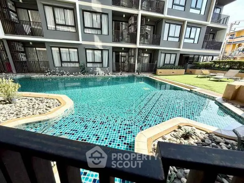 Luxurious apartment complex with sparkling pool and modern design