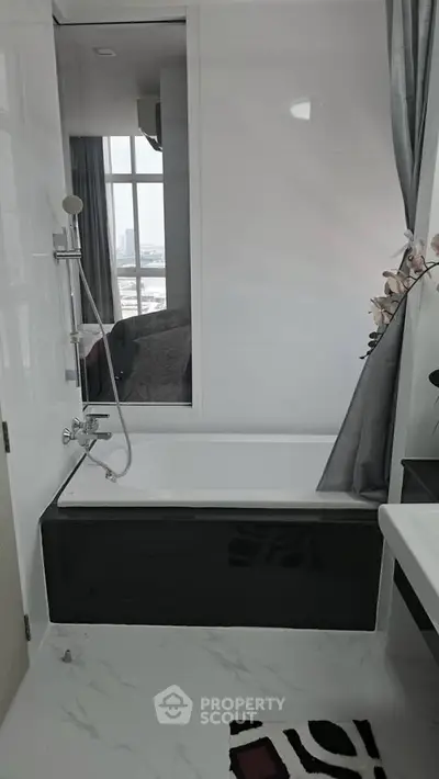 Modern bathroom with sleek bathtub and city view window, elegant design for luxury living.