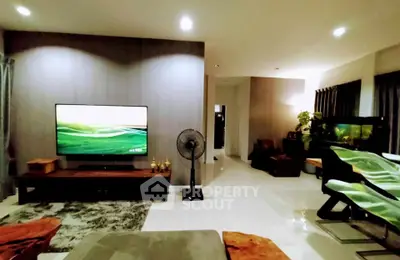 Spacious modern living room with large TV and stylish decor