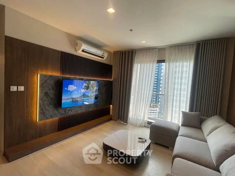 Modern living room with stylish decor and large window offering city view