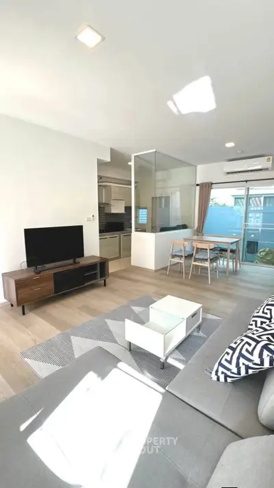 Modern living room with open layout, stylish furniture, and natural light in a contemporary apartment.
