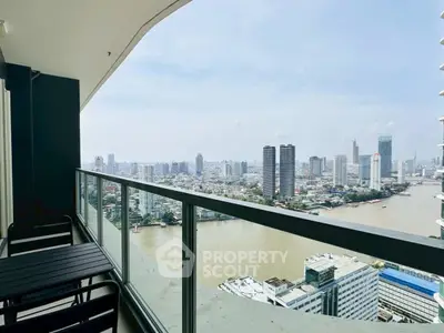Stunning high-rise balcony view overlooking city skyline and river, perfect for urban living.