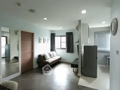 Modern living room with sleek design and natural light, featuring a comfortable sofa and stylish decor.