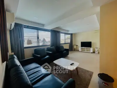 Spacious living room with modern furniture and large windows offering natural light.