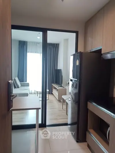 Modern apartment interior with open kitchen and cozy living room