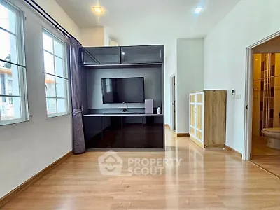 Spacious modern living room with sleek TV unit and large windows