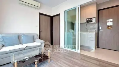 Modern living room with glass coffee table and compact kitchen