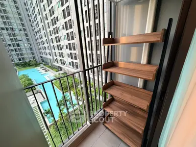 Charming balcony with pool view in modern apartment complex