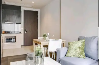 Modern living room with open kitchen and stylish decor in a cozy apartment.