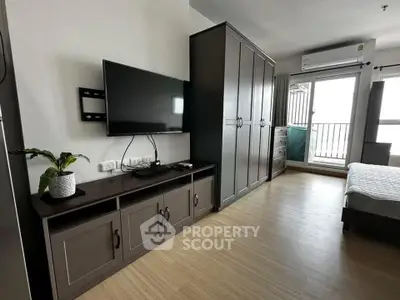 Modern bedroom with sleek wardrobe and balcony access in stylish apartment