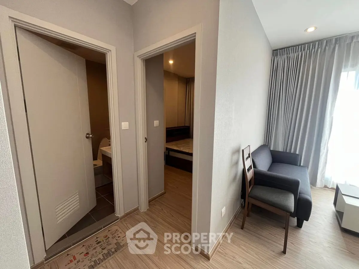 Modern apartment interior with cozy living area and bedroom entrance