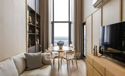 Modern living room with tall windows and elegant decor