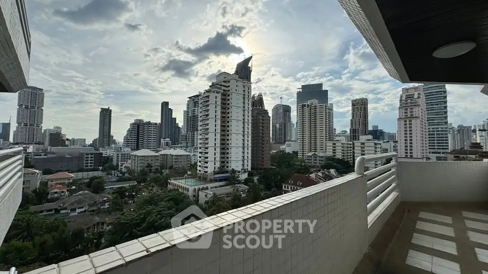 Stunning cityscape view from a high-rise balcony in a bustling urban area.