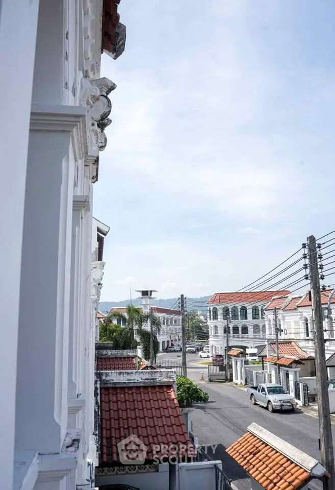Charming colonial-style street view with historic architecture and red-tiled roofs.