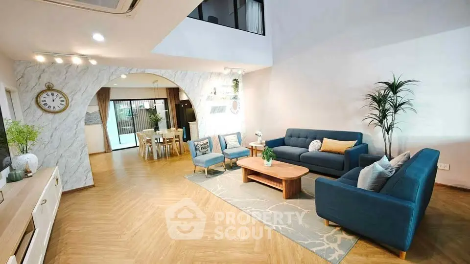 Spacious modern living room with stylish blue furniture and elegant decor