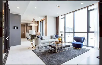 Luxurious modern living room with floor-to-ceiling windows and elegant furnishings.