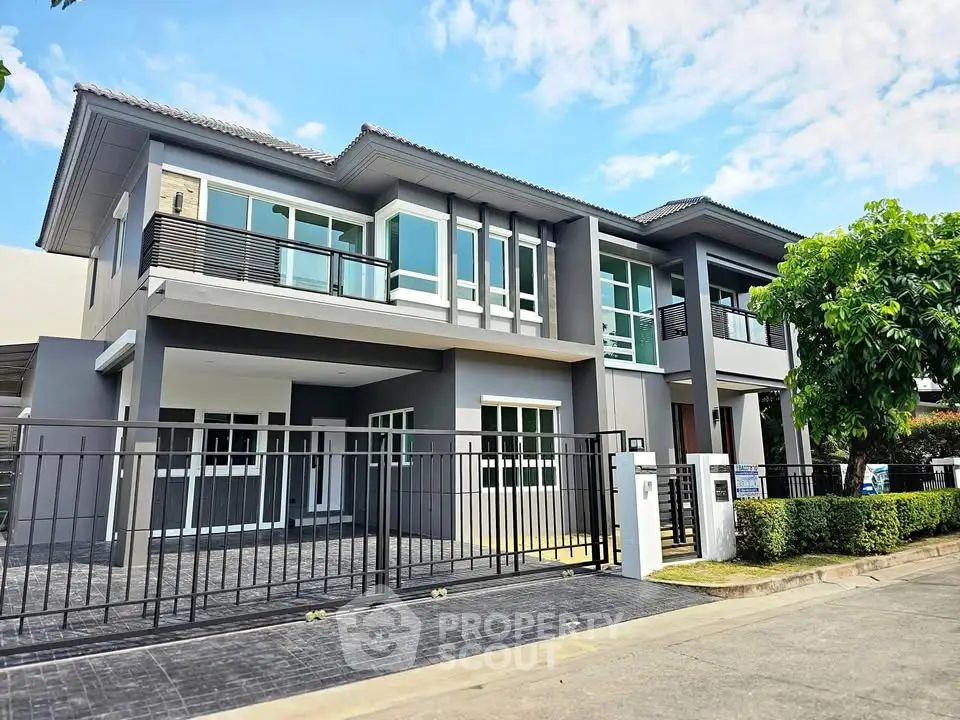 Modern two-story house with sleek design and spacious driveway