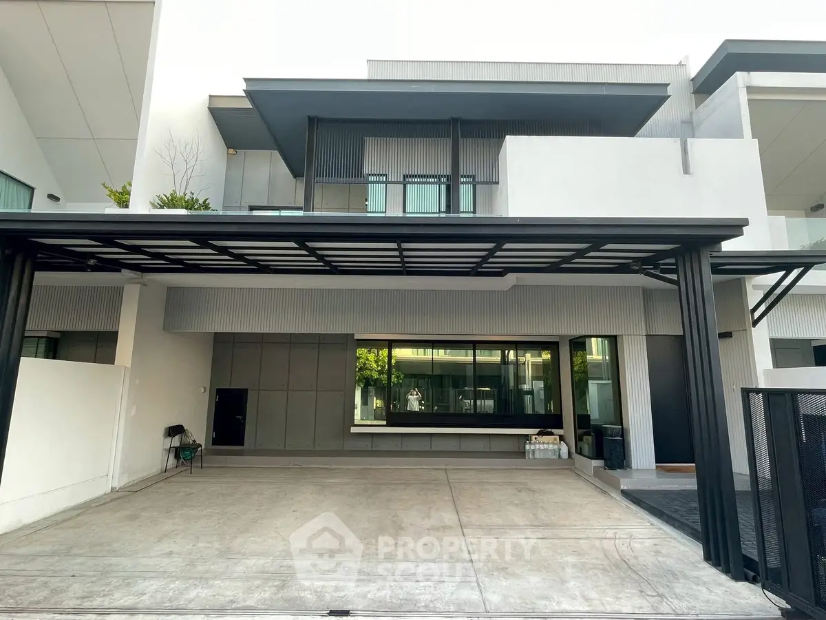 Modern two-story house with sleek design and spacious driveway