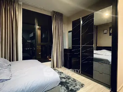 Luxurious bedroom with city view, elegant curtains, and modern wardrobe design.