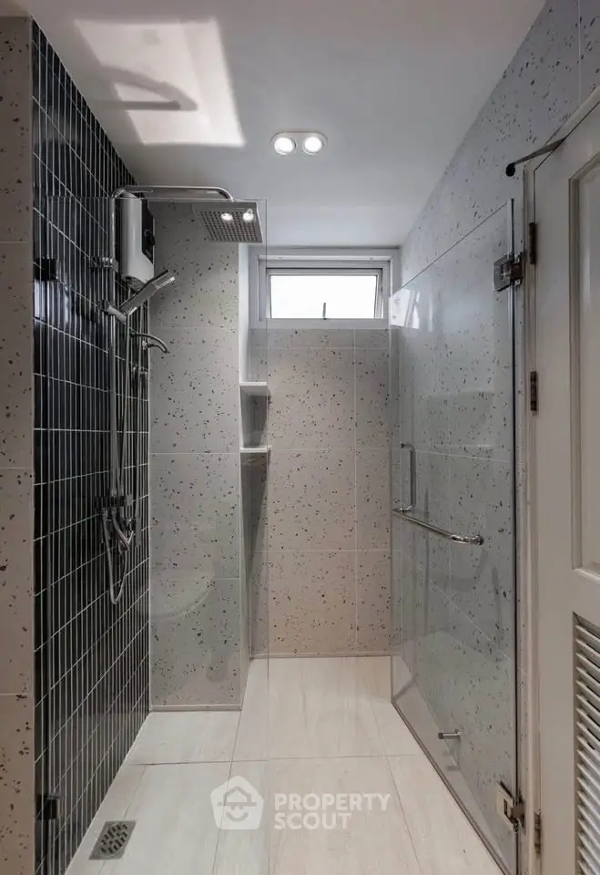 Modern bathroom with sleek shower design and stylish tile accents