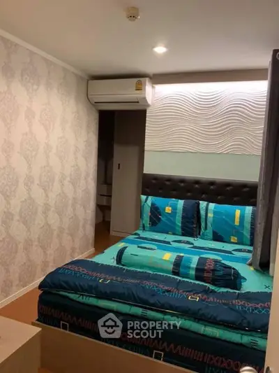 Cozy bedroom with modern decor and air conditioning in a stylish apartment.