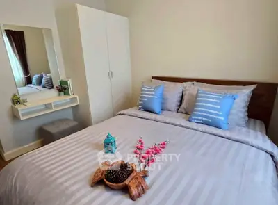 Cozy bedroom with stylish decor and ample natural light