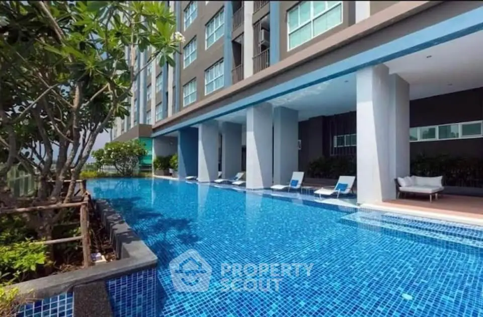 Luxurious condominium with stunning poolside view and modern architecture.