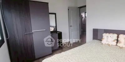 Cozy bedroom with modern wardrobe and stylish decor, perfect for relaxation.