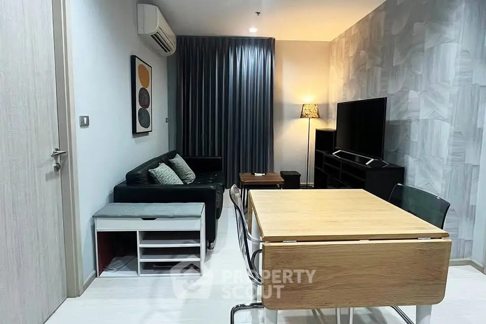 Modern living room with stylish decor and dining area in a cozy apartment.