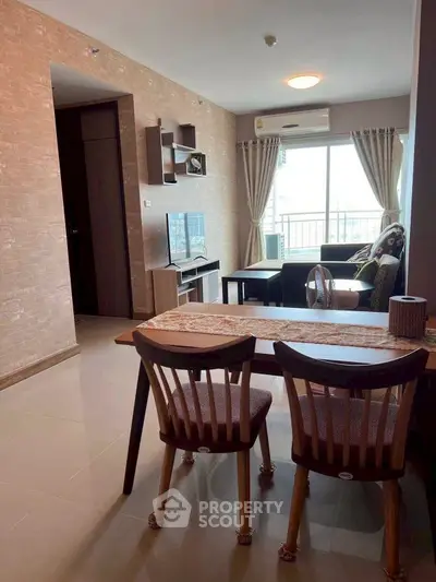 Modern living room with stylish decor and balcony view in a cozy apartment.