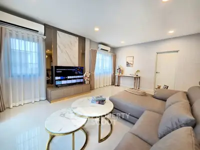 Spacious modern living room with elegant decor and cozy seating area.