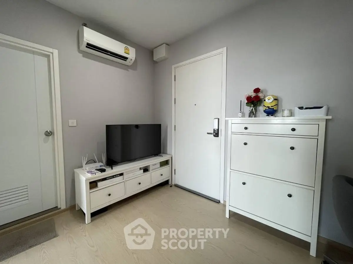 Modern living room with sleek furniture and air conditioning unit