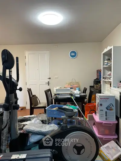 Cozy room with exercise equipment and storage shelves, ideal for a home gym or multi-purpose space.