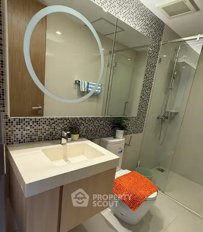 Modern bathroom with stylish vanity and glass shower enclosure