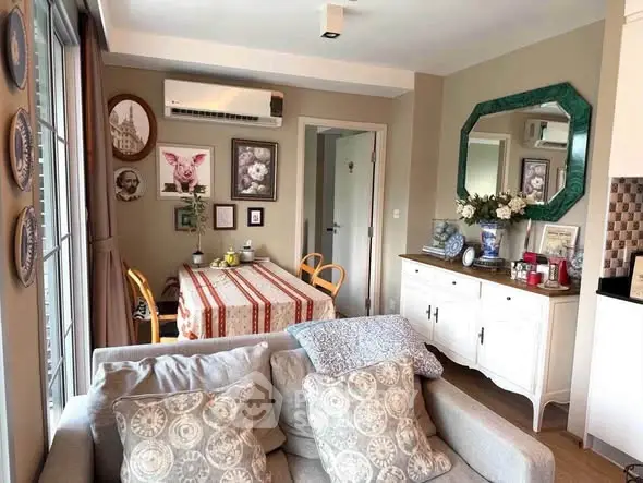 Charming living room with cozy decor and dining area in modern apartment.