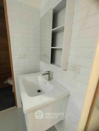 Modern bathroom with sleek white sink and stylish wall tiles