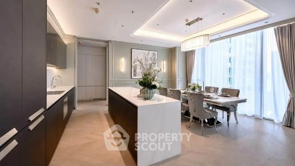 Luxurious open-layout kitchen and dining area with elegant decor and natural light.