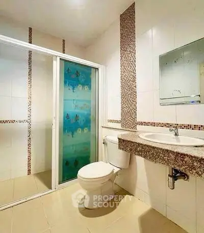 Modern bathroom with glass shower and elegant tile accents