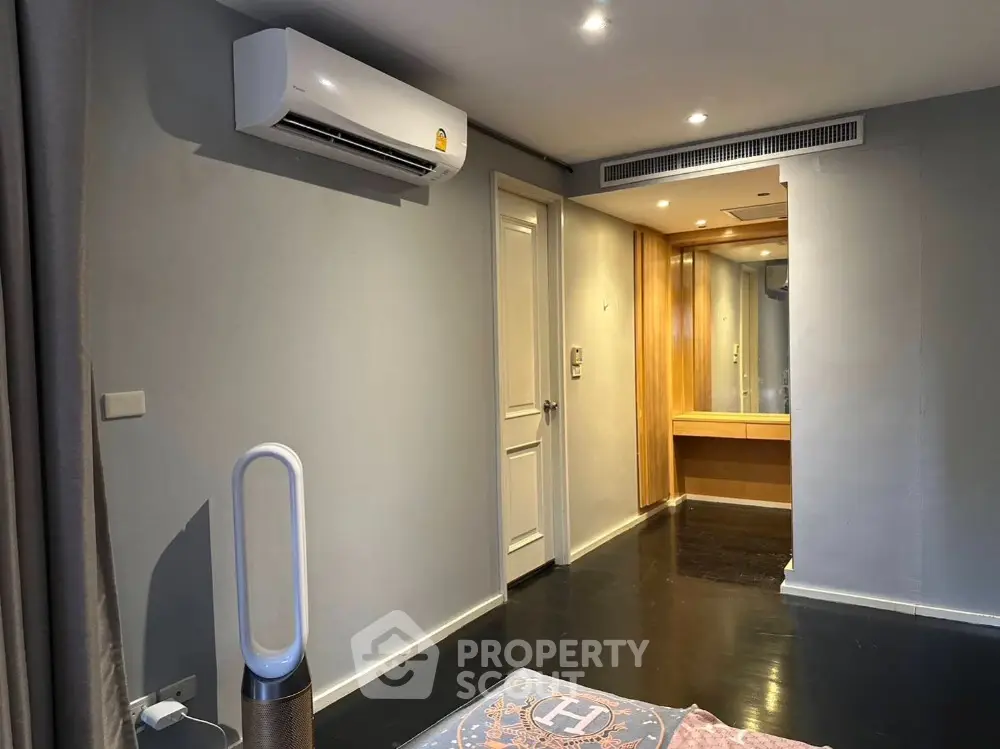 Modern bedroom with air conditioning and sleek flooring