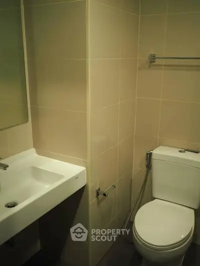 Modern bathroom with sleek fixtures and neutral tiles, perfect for a contemporary home.