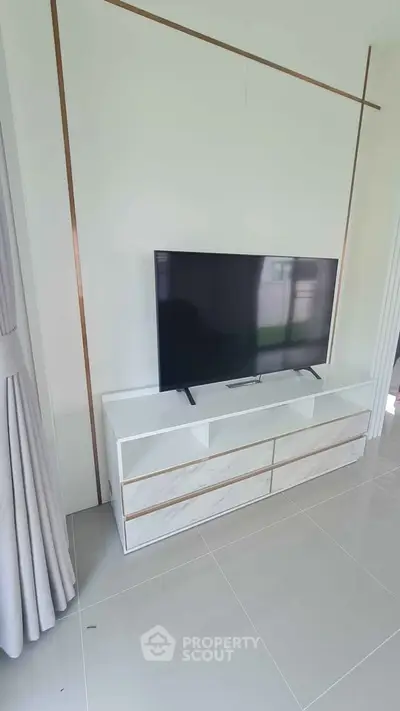 Modern living room with sleek TV stand and elegant curtains