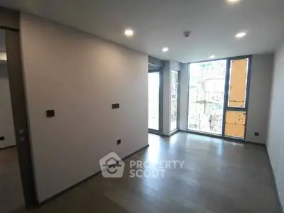 Spacious modern room with large windows and sleek flooring